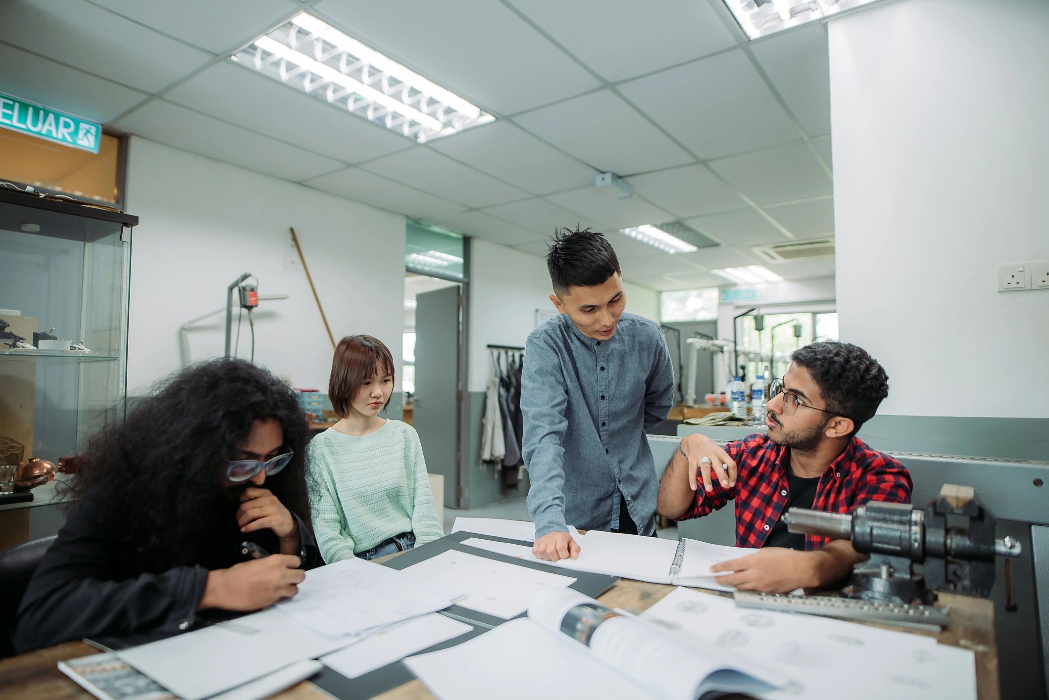 Teacher assisting students in a vocational classroom