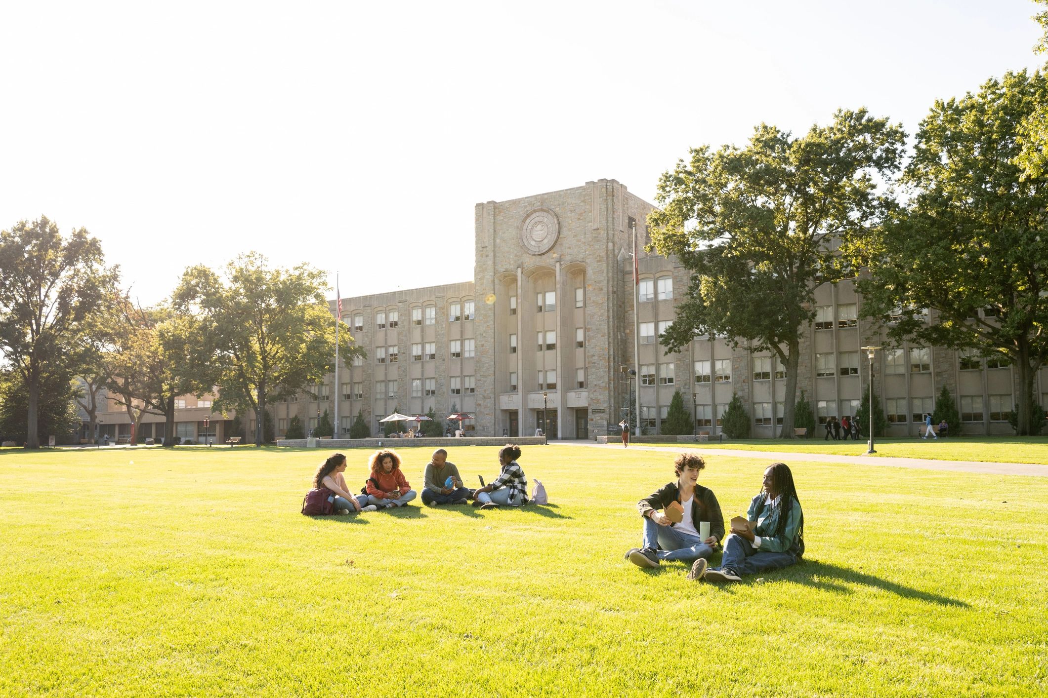 University students gathered on a campus lawn